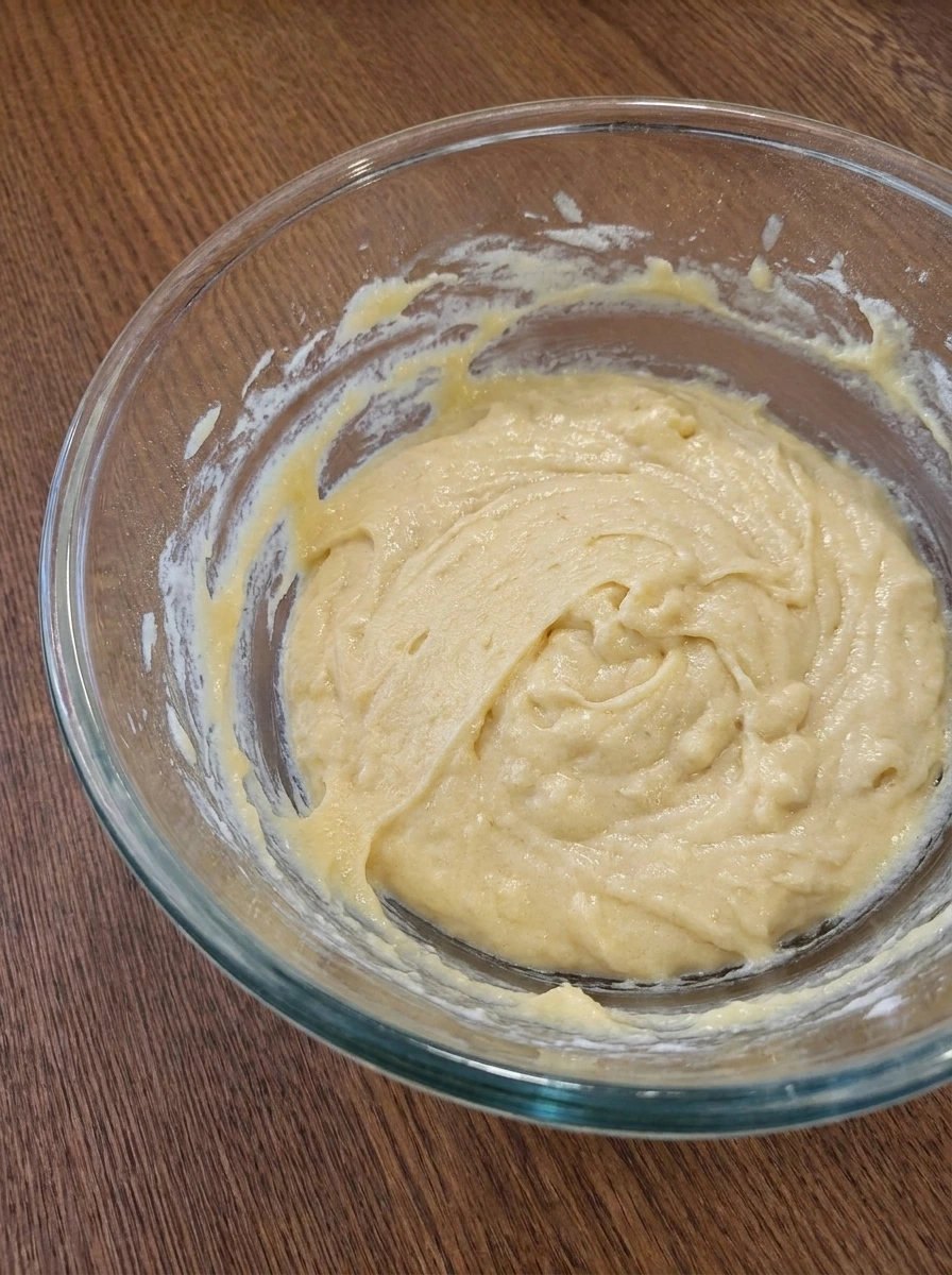 Thick cake batter for Rhubarb Cake in a mixing bowl.