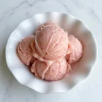 Rhubarb Sorbet with pink scoops in a white bowl