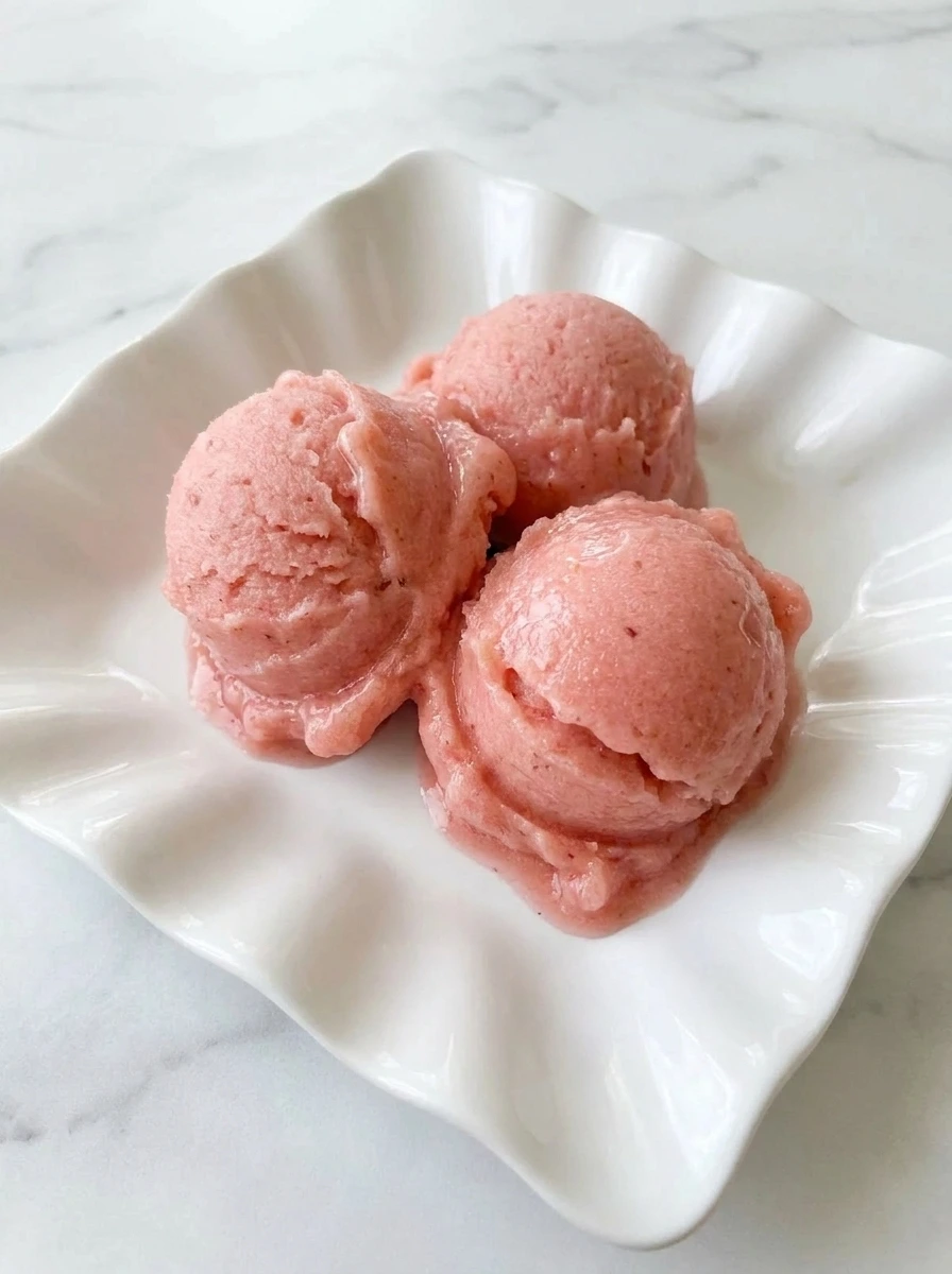 Scooped Rhubarb Sorbet served in a white bowl