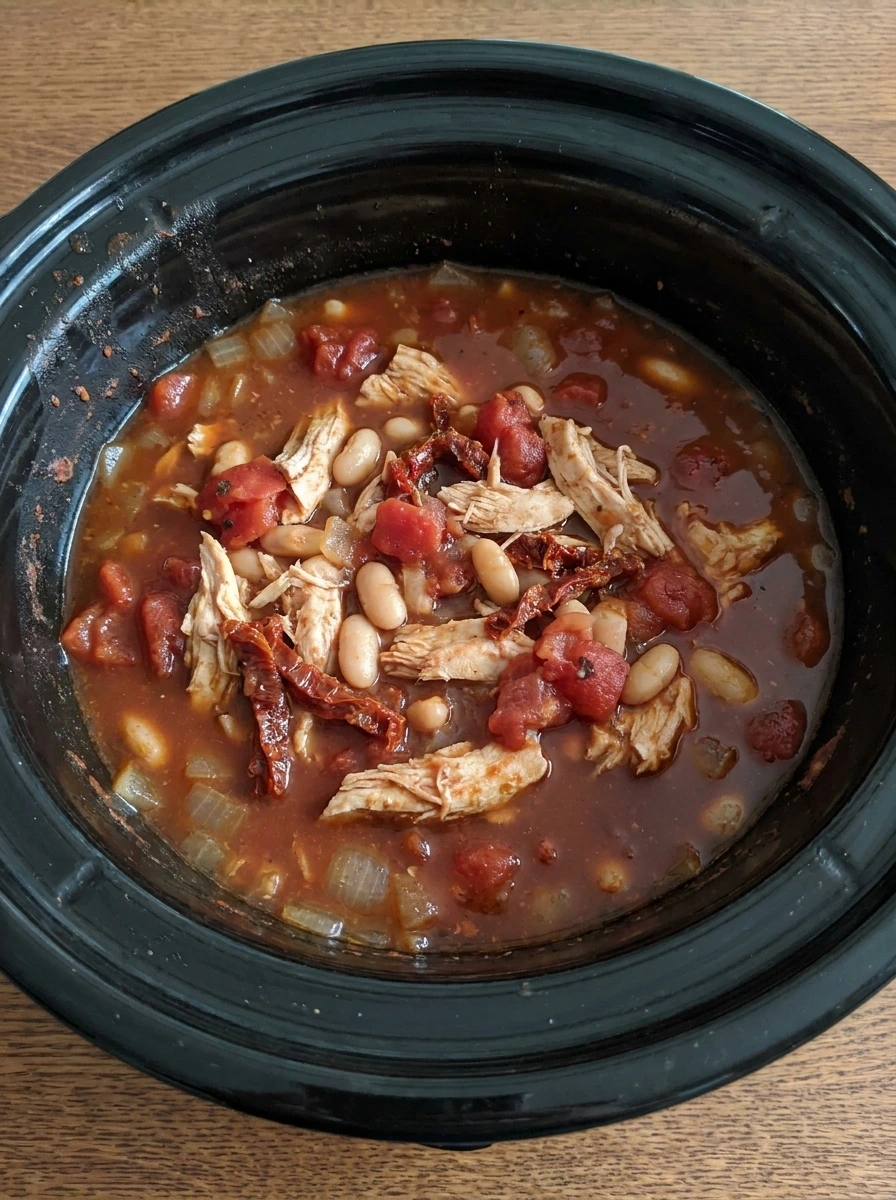 Cooked chicken shredded in Tuscan soup with beans and tomatoes.