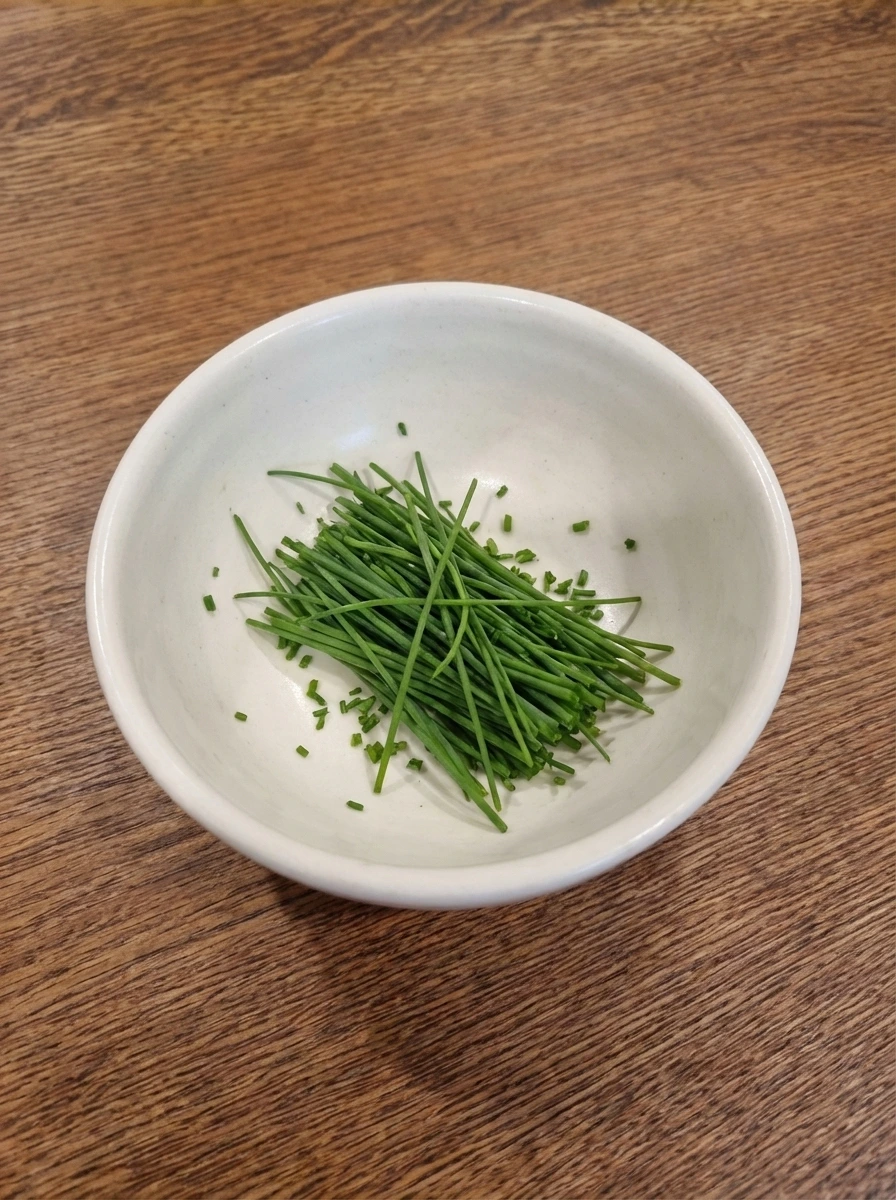 Finely sliced chives in a white dish for Soft Scrambled Eggs
