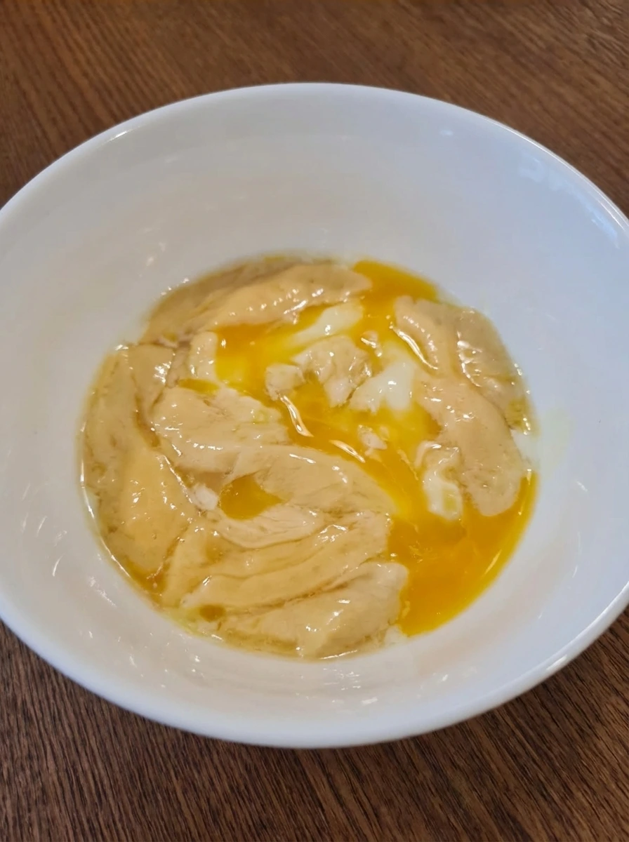 Soft Scrambled Eggs beginning to set into silky streaks in a white dish