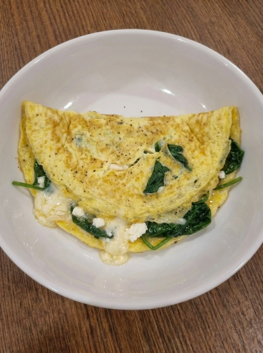 Finished Spinach Cheese Omelette with browned spots and melted cheese