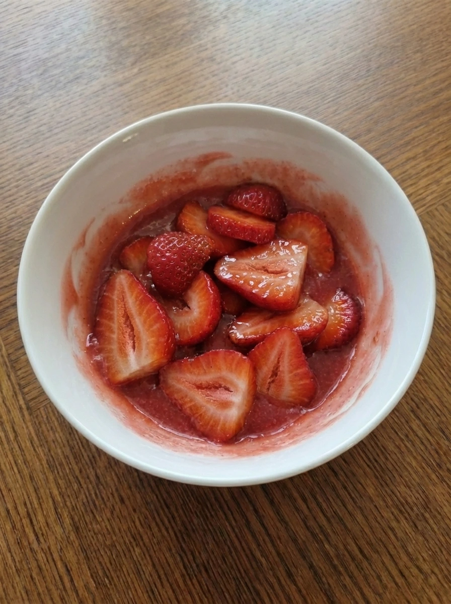 Glazed strawberry filling spread into a natural white dish with uneven top