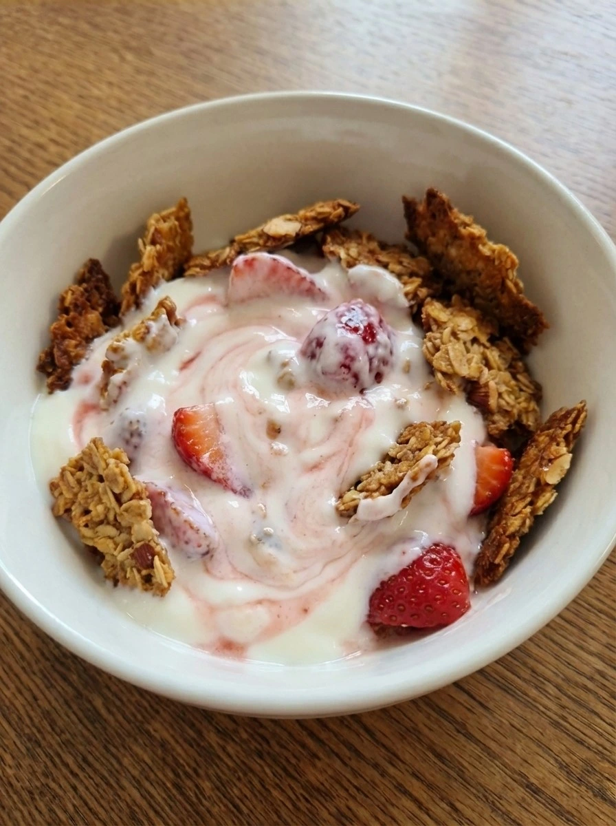 Finished Strawberry Crackle Salad topped with uneven golden crackle in a white dish