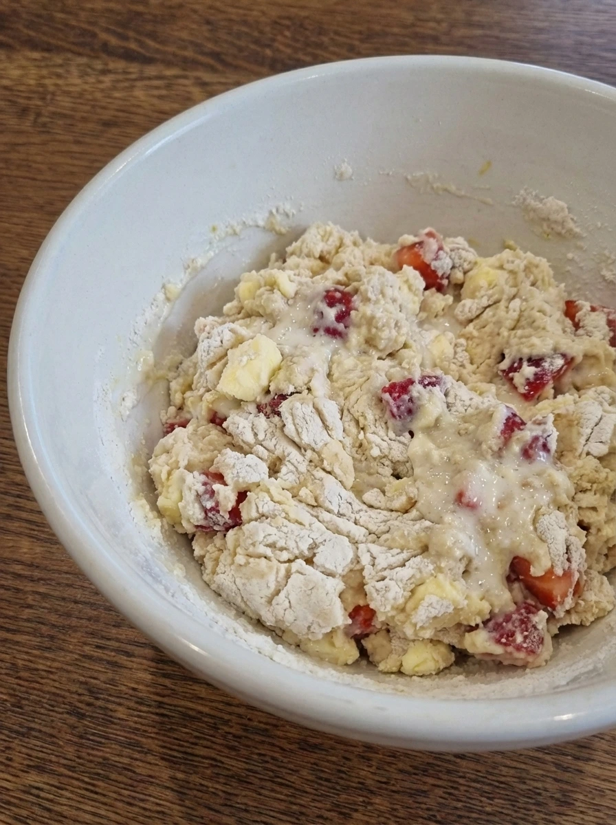 Rough strawberry scone dough just mixed in a white dish