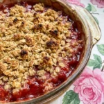 Strawberry Rhubarb Crumble with golden oat topping and bubbling fruit