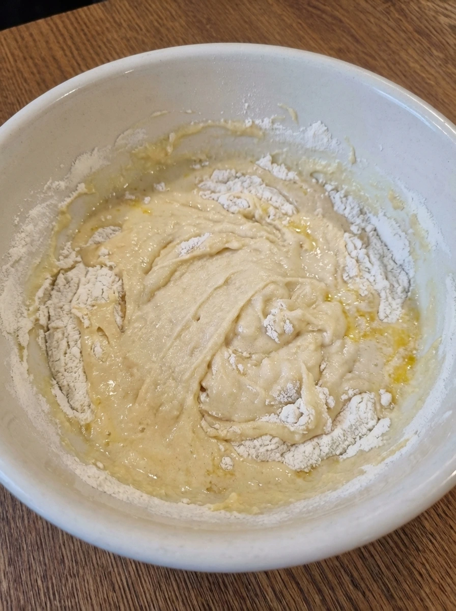 Partially mixed batter for Strawberry Upside Down Cake in a natural white dish