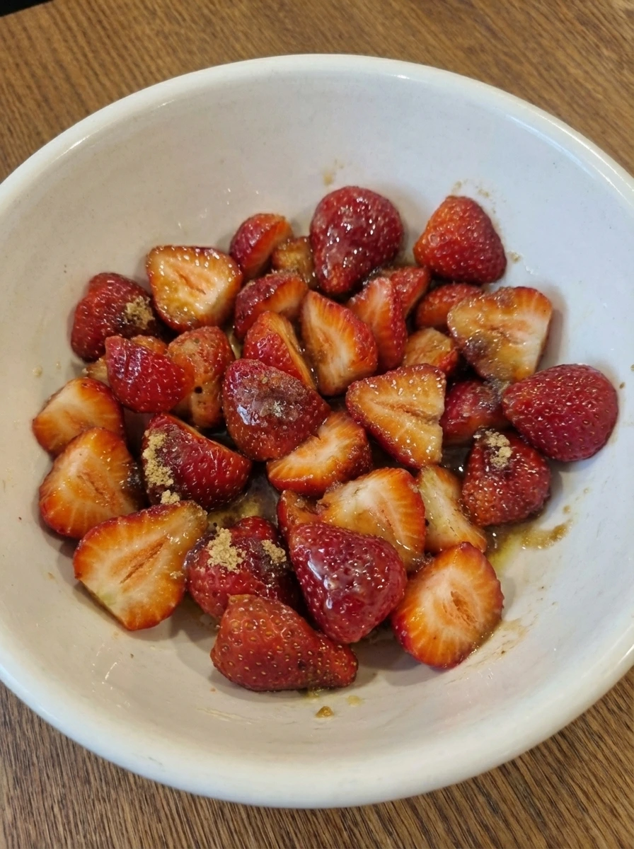 Strawberries coated with butter and brown sugar for Strawberry Upside Down Cake