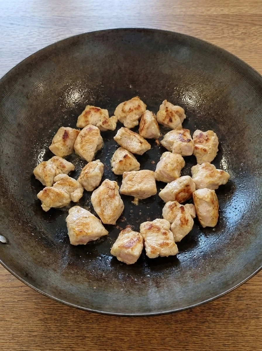 Chicken pieces browning in the wok for Sweet and Sour Chicken