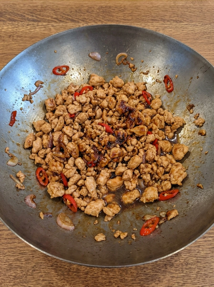 Thai Basil Chicken coated in glossy brown sauce.
