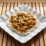 Crockpot Cajun Butter Chicken cooked in a slow cooker with rich red sauce
