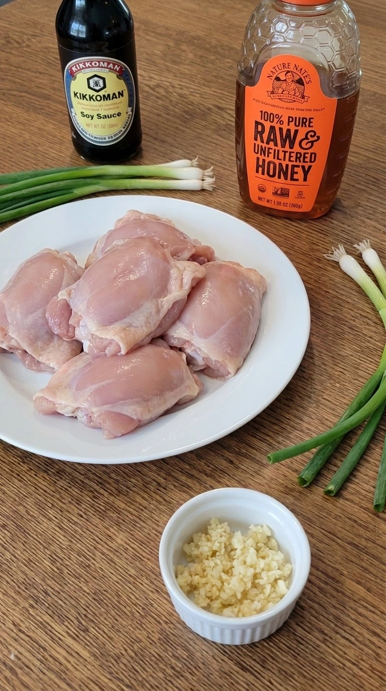 Raw ingredients for Crockpot Honey Garlic Chicken including chicken thighs, honey, and garlic