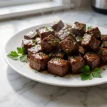 Crockpot Steak Bites coated in rich garlic butter sauce