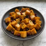 Maple Roasted Butternut Squash with Cranberries with glossy roasted squash cubes and cranberries