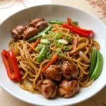 Slow Cooker Lo Mein with glossy chicken, red bell pepper, snap peas and sesame seeds