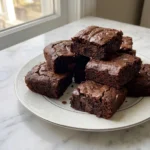 Sweet Potato Brownies stacked squares with glossy chocolate tops