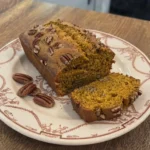 Almond Flour Pumpkin Bread with a sliced golden loaf showing its moist pumpkin crumb. Recipe focus: pumpkin bread with almond flour.