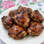 Banana BBQ Chicken with glossy mahogany glazed chicken pieces on a white plate Recipe focus: bbq chicken crockpot easy.