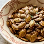Chili Roasted Pumpkin Seeds with a glossy smoky chili coating and crisp toasted edges Recipe focus: how to make chili roasted pumpkin seeds.