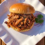 Crockpot BBQ Chicken with glossy shredded barbecue chicken on a sandwich bun Recipe focus: crockpot bbq chicken recipes.