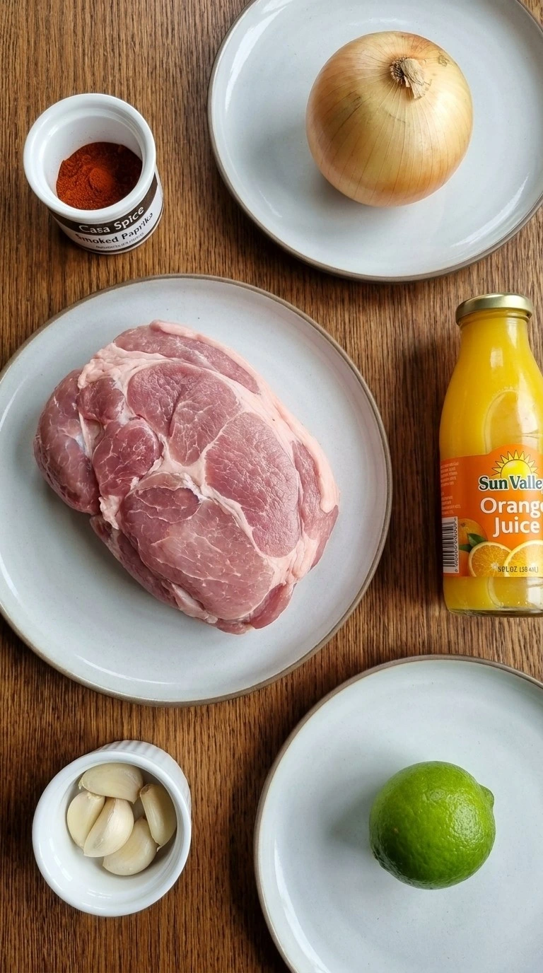 Crockpot Carnitas ingredients with pork shoulder spices and fresh aromatics Recipe focus: pork carnitas tacos.