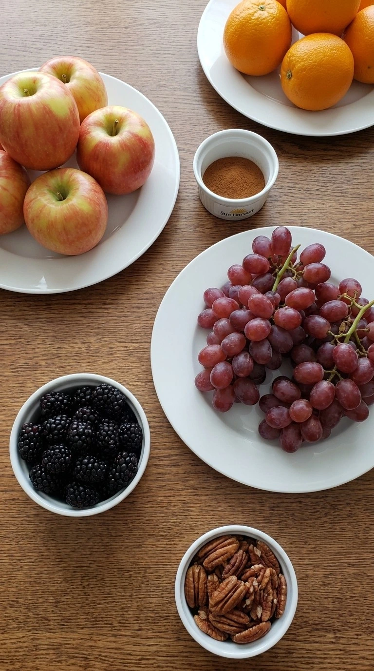 Fall Fruit Salad Thanksgiving Sides ingredients including apples grapes berries oranges cinnamon and pecans