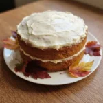 Friendsgiving Cake with autumn leaf decorations and creamy frosting Recipe focus: friendsgiving cake ideas.