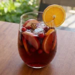 Friendsgiving Cocktail Party drink with cranberry apple sangria in glasses