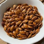 Honey Roasted Pumpkin Seeds with glossy amber honey glaze, warm spices and toasted sesame seeds Recipe focus: how to make honey roasted pumpkin seeds.
