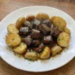 Slow Cooker Garlic Butter Beef Bites and Potatoes finished with glossy garlic butter beef cubes Recipe focus: crockpot garlic butter steak bites and potatoes.
