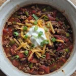 Crockpot Chili in a bowl with thick beef, beans, and rich tomato texture Recipe focus: chili recipe.