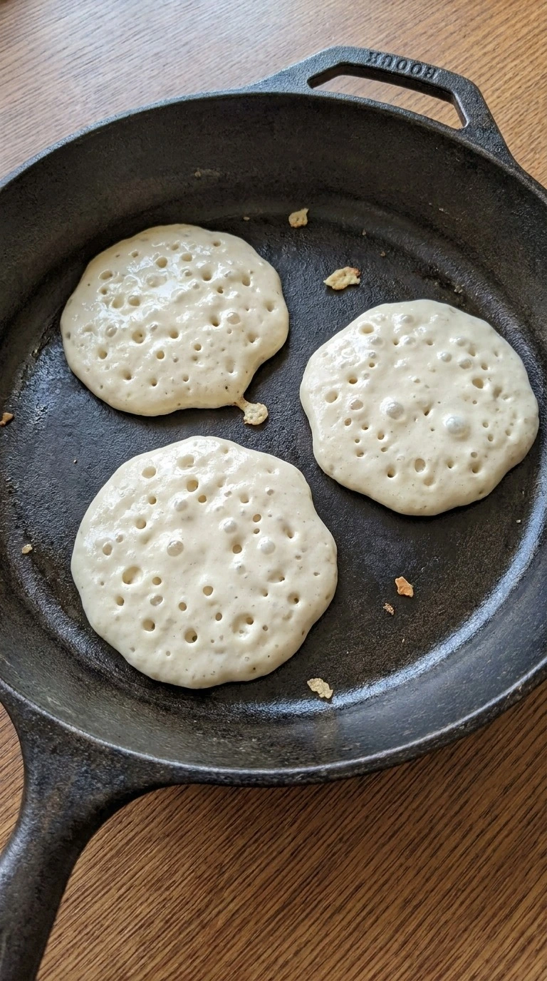 Bubble covered pancakes cooking for Fluffy Buttermilk Pancakes from Scratch Recipe focus: homemade pancakes from scratch.