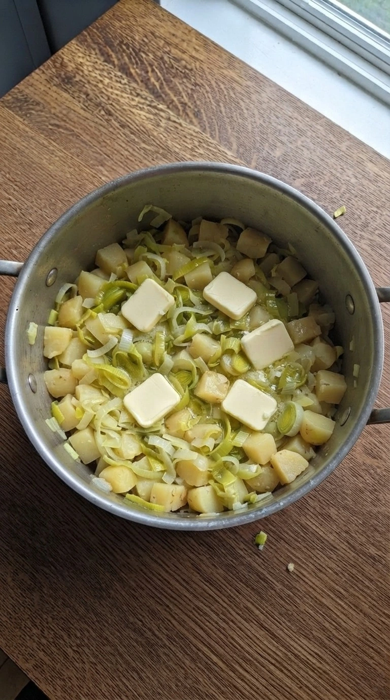 Potato Leek Soup leeks softening in butter inside a pot Recipe focus: potato leek soup recipe.