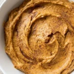 Pumpkin Pie Dip in a serving bowl with creamy pumpkin texture and cinnamon swirls Recipe focus: pumpkin fluff dip.
