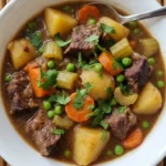 Slow Cooker Beef and Vegetable Stew with seared chuck, potatoes, carrots and peas in thick brown gravy Recipe focus: slow cooker beef stew.