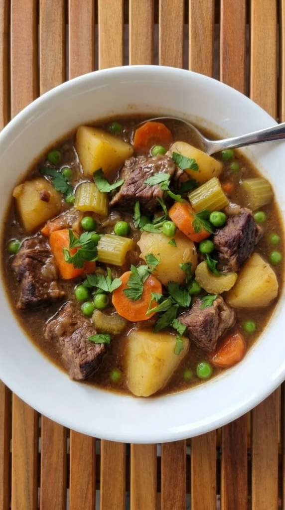 Slow Cooker Beef and Vegetable Stew with seared chuck, potatoes, carrots and peas in thick brown gravy Recipe focus: slow cooker beef stew.