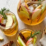 Apple Cider Sangria in glasses with apple slices orange rounds and cinnamon Recipe focus: apple cider sangria Recipe focus: apple cider sangria recipe easy.