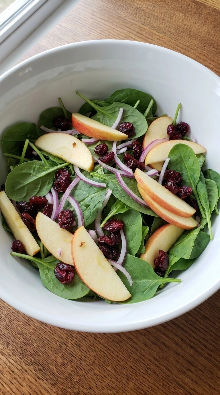 Apple Cranberry Salad greens layered with Honeycrisp apple slices, red onion and dried cranberries Recipe focus: easy apple cranberry salad.