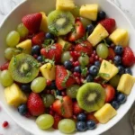 Christmas Fruit Salad with colorful fresh fruit in a serving bowl Recipe focus: christmas salad.