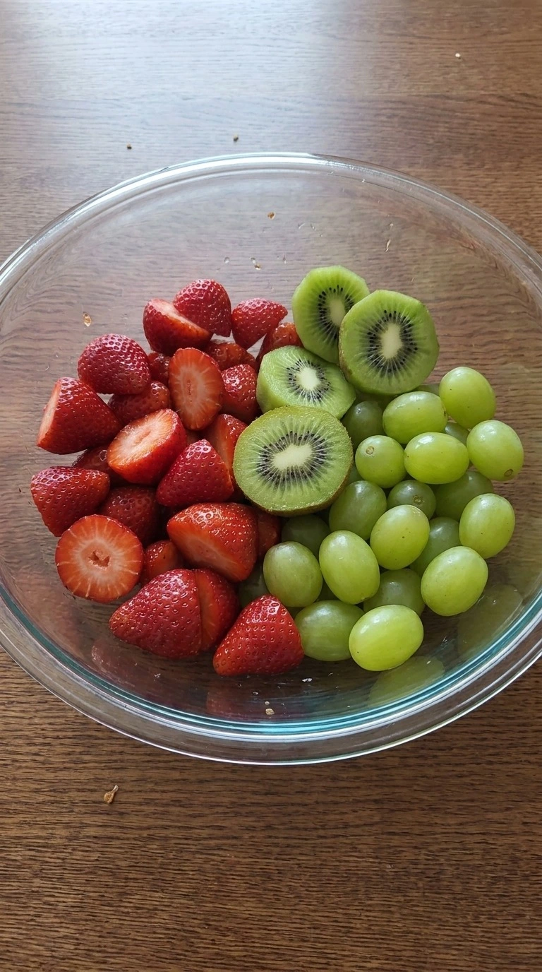 Christmas Fruit Salad fresh sliced fruit in a mixing bowl Recipe focus: green christmas salad.