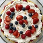 Christmas Trifle with layered cake custard cream and berries in serving dish Recipe focus: christmas trifle easy.