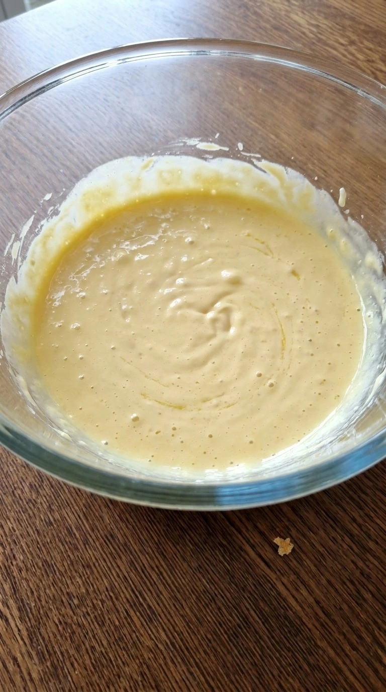 Corn Casserole with Jiffy Mix wet ingredients whisked into a smooth pale yellow mixture. Recipe focus: easy corn casserole with jiffy mix.