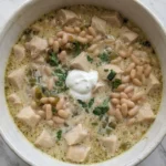 Creamy White Chicken Chili in a bowl with tender chicken and creamy broth Recipe focus: crockpot white chicken chili.