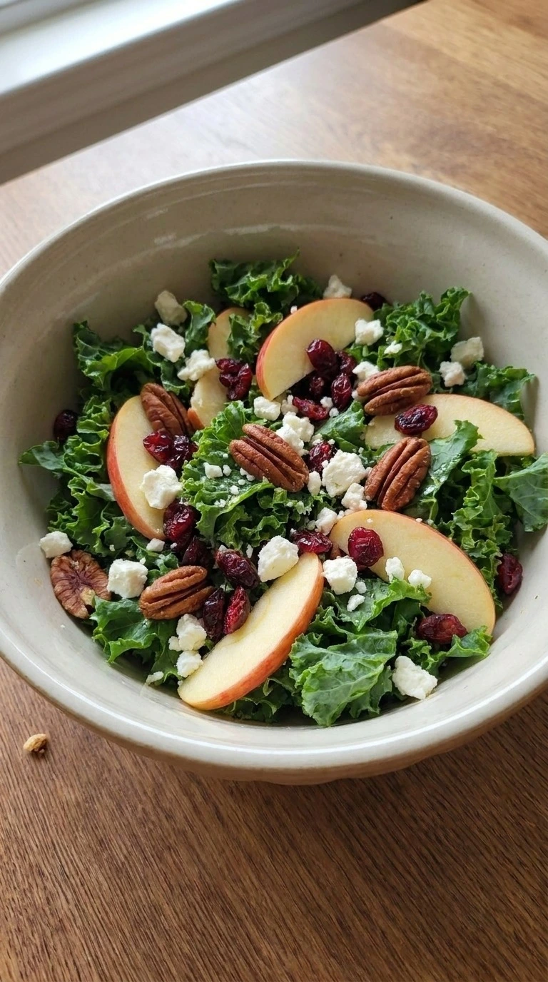 Fall Harvest Salad with kale apples cranberries pecans and feta mixed Recipe focus: fall kale salad.