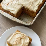 Pumpkin Spice Cake with cream cheese frosting and a square slice showing the moist orange crumb. Recipe focus: easy pumpkin spice cake.