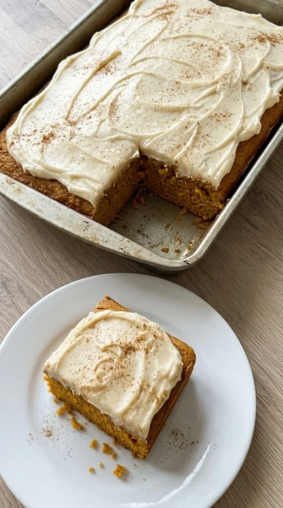 Pumpkin Spice Cake with cream cheese frosting and a square slice showing the moist orange crumb. Recipe focus: easy pumpkin spice cake.