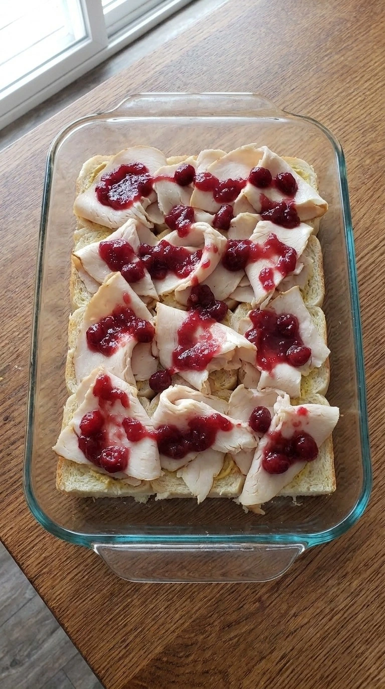 Turkey Cranberry Sliders layered with folded roasted turkey breast and whole berry cranberry sauce Recipe focus: turkey cranberry sliders recipe.